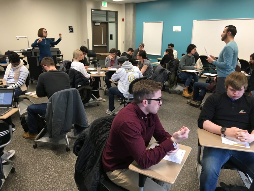 Rebekah Sims and Hadi Banat Team-Teaching, Spring 2018. Photo includes a classroom with students.